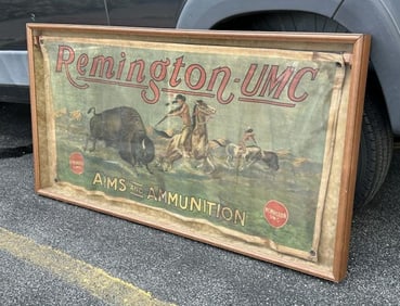 REMINGTON UMC original polychromed cloth advertising banner, hanging in oak shadowbox frame, was in