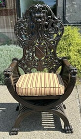 Heavily carved oak highback chair with Northwind God on top and heads in the arms, from fine Hudson