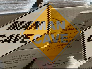 9 cases MAN CAVE tin embossed signs plus loose ones (18" X 18")