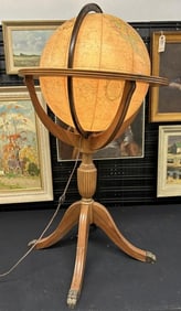 16" round globe on pedestal floor stand, it lights up, stands approx. 38" high, on a mahogany base,