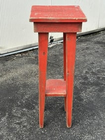 Contemporary red small country stand, nicely worn paint, measures 28" high x 11" 11" top.