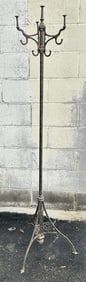 Circa 1900 brass and iron coat rack ,measures 65" H, nice old patina, has stars on base.