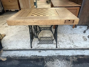 Wonderful custom made game table on cast iron sewing machine base, has inlaid checker board that