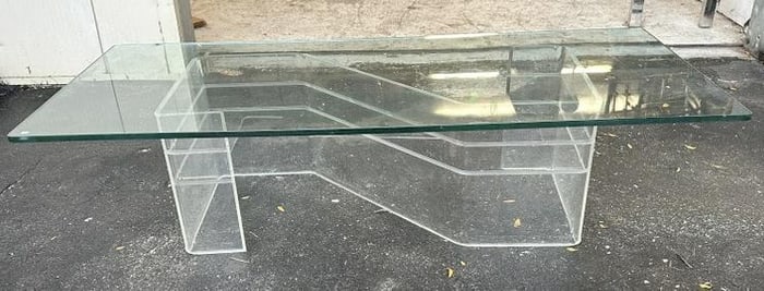 Mid century plate glass coffee table w/lucite base, chip in glass top on underside near 1 corner,