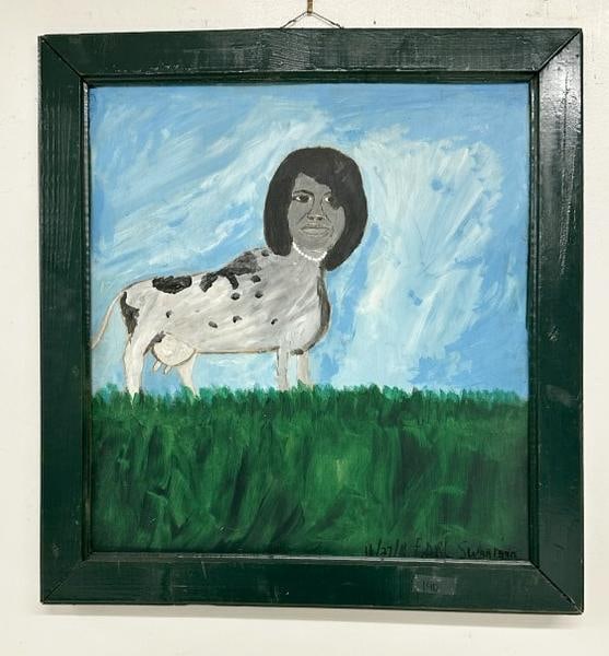 Outsider Artist Earl Swanigan (1964 - 2019) o/b Michelle Obama head on cow body, signed lower right,: Outsider Artist Earl Swanigan (1964 - 2019) o/b Michelle Obama head on cow body, signed lower right, dated 11/27/10. Painting measures 21.5" x 20", the frame measures 26" x 24", nice condition. From t