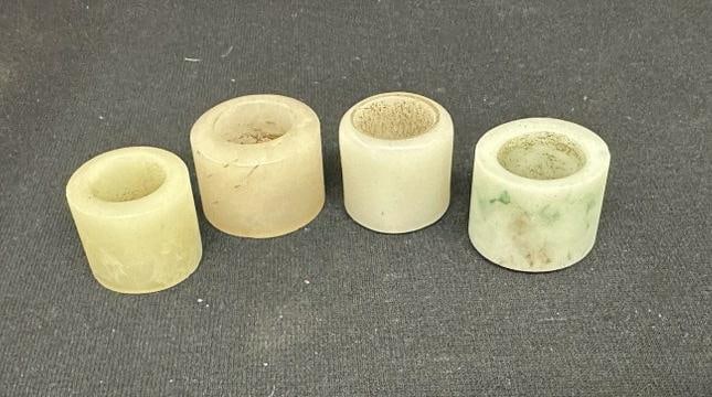 (4) jade or hard stone archers rings, small rim nick on greenish one, just as we found them. From (1 of 3)