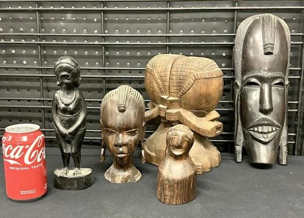 African carvings lot to incl. bookends, mask, and figures, from estate in Hyde Park, New York, just: African carvings lot to incl. bookends, mask, and figures, from estate in Hyde Park, New York, just as we found them, the mask measures 13" high to show scale.