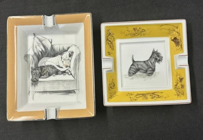 (2) HERMES ashtrays with Scottish Terriers, in fine condition. They measure 8" x 6.5" and 6.25" x