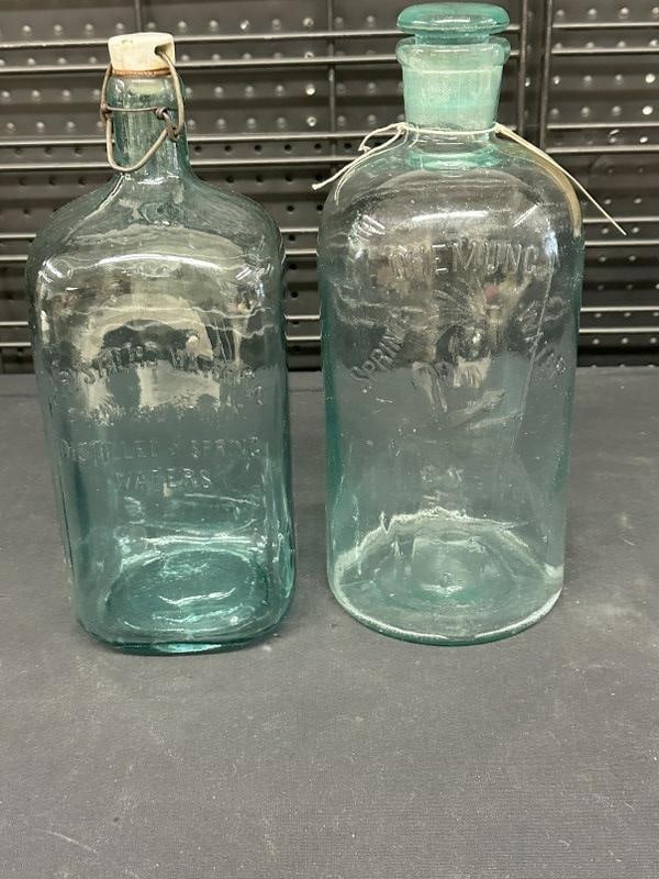 (2) early blue glass water bottles, found in stone house in Hudson Valley, both with stoppers and in: (2) early blue glass water bottles, found in stone house in Hudson Valley, both with stoppers and in nice overall condition. They are CHEMUNG SPRING WATER with an Indian on bottle, measures 12.5" high