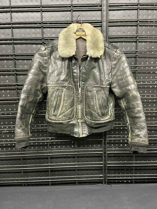 Cool vintage small size leather bomber jacket, nice wear to patina on leather, tattered material on: Cool vintage small size leather bomber jacket, nice wear to patina on leather, tattered material on sleeves and waiste. A young girl wore this years ago….measures approx. 16" across the shoulders x