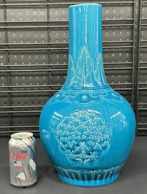 Asian 16.5" high blue decorative vase with flowers on sides, and leaves around the neck, in fine