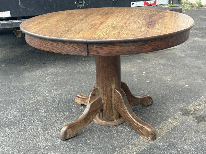 Circa 1910 round oak table, from local estate, measures 42" across x 28" high, structurally: Circa 1910 round oak table, from local estate, measures 42" across x 28" high, structurally sound…..( missing small block of wood off one foot as pictured ).