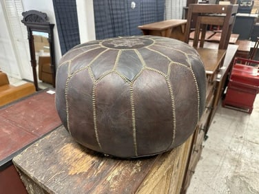Moroccan leather pouf in nice clean condition, measures 21.5" wide x 13" high.