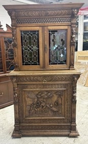 Wonderful Continental heavily carved (2) part cabinet with leaded glass doors on the top, and