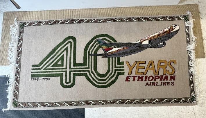 Commemorative handmade wool advertising rug for the 40th anniversary of Ethiopian Airlines, covering: Commemorative handmade wool advertising rug for the 40th anniversary of Ethiopian Airlines, covering 1946-1986. Possibly given to Executives on this anniversary, in fine condition, appears to have bee