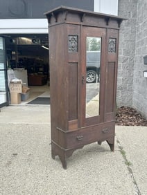 Oak armoire with mirror on door, has some affixed shelves inside, and some loose trim pieces, has a