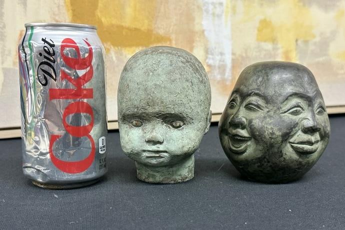 (2) small heads, one bronze with (4) faces all the way around, and other is either cast stone or (1 of 4)