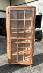 19th c pine corner cabinet with (2) glass doors, has reminents of old reddish paint, measures 66.5"