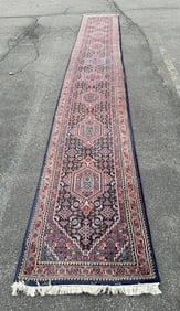 Very long handmade wool oriental runner, thick pile, excellent condition, measures 226.5" x 31". A