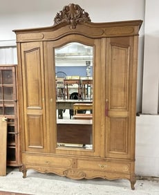 Wonderful oversized oak armoire with beveled mirror on the door, wood rods not there, from fine