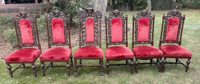 Wonderful set of (6) heavily carved hardwood Jacobean style dining chairs with (1) larger head