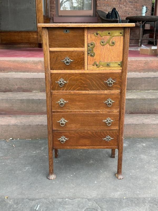 Circa 1910 diminutive oak dresser with unusal feet ( missing small piece of foot ), structurally: Circa 1910 diminutive oak dresser with unusal feet ( missing small piece of foot ), structurally sound, at one point the door was refinished…..measures 24" wide x 14" deep x 45" high.