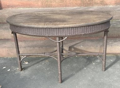 Oval wicker table with oak top, structurally sound, from local home in Hudson Valley. Measures 48"