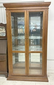 1970's oak display cabinet with mirrored back and beveled glass doors with adjustable shelves, from