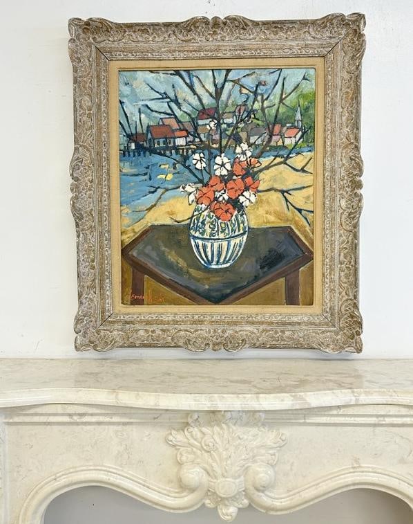 Wonderful French o/b impressionist floral still life with flowers in vase on table and buildings in: Wonderful French o/b impressionist floral still life with flowers in vase on table and buildings in background, in very nice decorative carved frame with ( MADE IN FRANCE )stamped on back. I can't mak