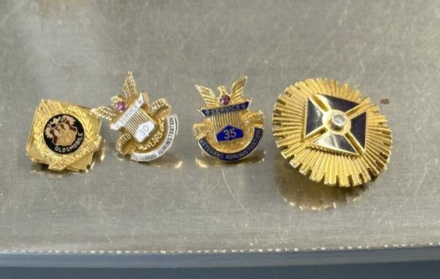 Estate lot 10K pins…..( Veterans Administration, Oldsmobile Point Club and one with a diamond chip: Estate lot 10K pins…..( Veterans Administration, Oldsmobile Point Club and one with a diamond chip in center ), total weight is 7.2 pennyweights…..