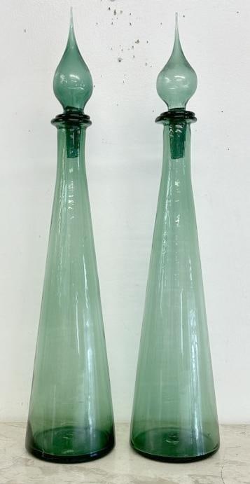 Pair Mid Century Modern Empoli green art glass genie bottles, with matching stoppers ( one stopper: Pair Mid Century Modern Empoli green art glass genie bottles, with matching stoppers ( one stopper has a small chip on tip, does not detract from overall appearance….They measure 25" high.