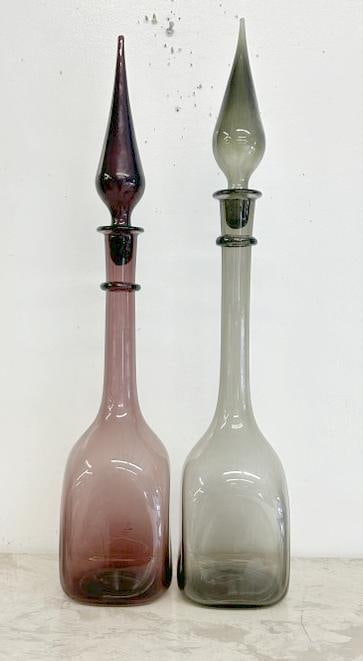 (2) Mid Century era genie bottle art glass tall decanters with stoppers, from nice estate in Hudson: (2) Mid Century era genie bottle art glass tall decanters with stoppers, from nice estate in Hudson Valley. Nice estate condition, they measure 25" and 26" high.