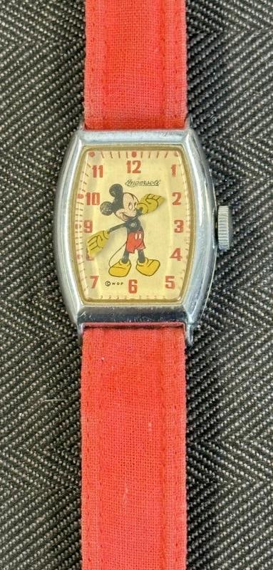 1930's INGERSOLL Mickey Mouse wrist watch, with red cloth band, when wound it does not run….case (1 of 4)