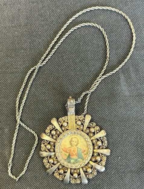 Old religious double sided pendant, with what looks like a sterling chain, possibly set in silver: Old religious double sided pendant, with what looks like a sterling chain, possibly set in silver (?), pendant measures 3.25" top to bottom….from fine estate in Poughkeepsie, N.Y.