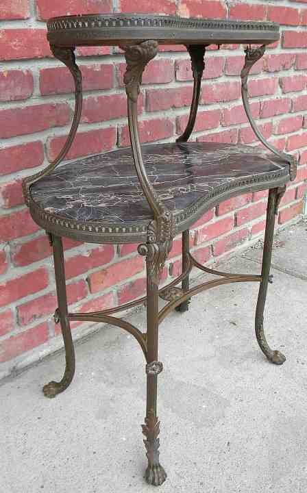 Unusual Bronze & Black Marble Decorative 2 Tier Stand: Unusual Bronze & Black Marble Decorative 2 Tier Stand, from NYC apartment, not signed, wonderful kidney shape, in original condition. Missing 2 rosettes from base...Measures 32 1/4" high, 24" wide and