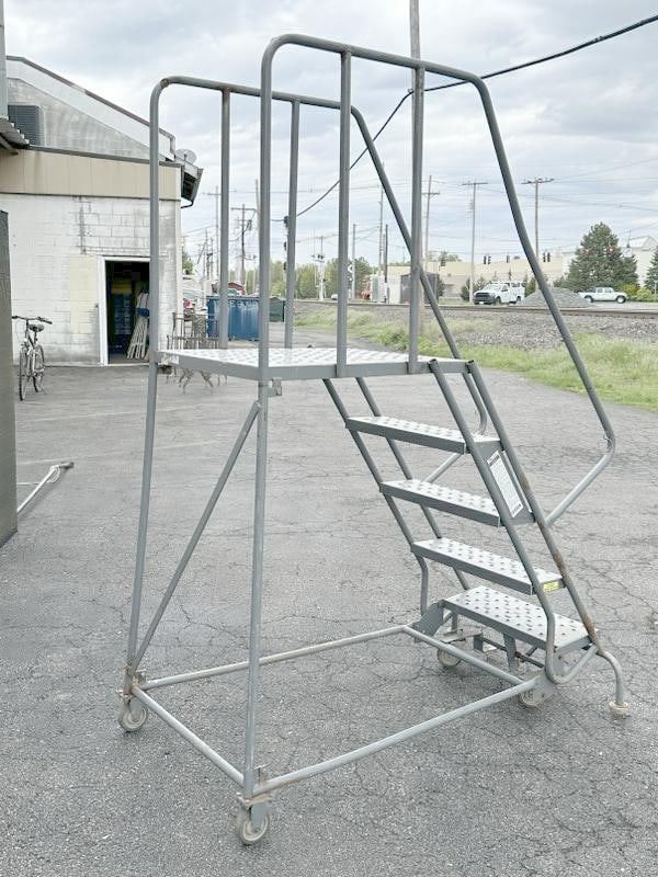 Portable warehouse ladder on wheels, standing deck measures 50" high. Nice overall condition. (1 of 1)