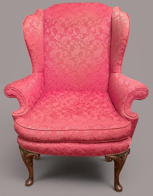 Nice older wing chair with reddish decorative fabric, nicely carved feet, structurally sound, from (1 of 2)