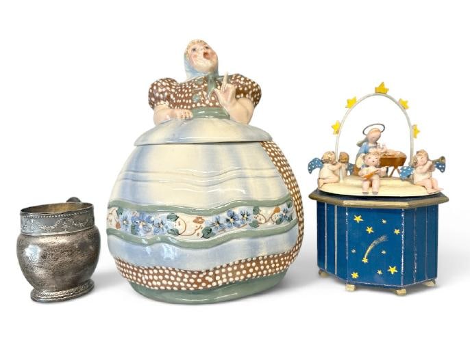 (3) pc. Lot to include sterling silver baby's cup, Helen Hutula Tat L Tale cookie jar and STEINBACH: (3) pc. Lot to include sterling silver baby's cup, Helen Hutula Tat L Tale cookie jar and STEINBACH music box with figures, nice overall estate condition. 5.71 troy ounces.