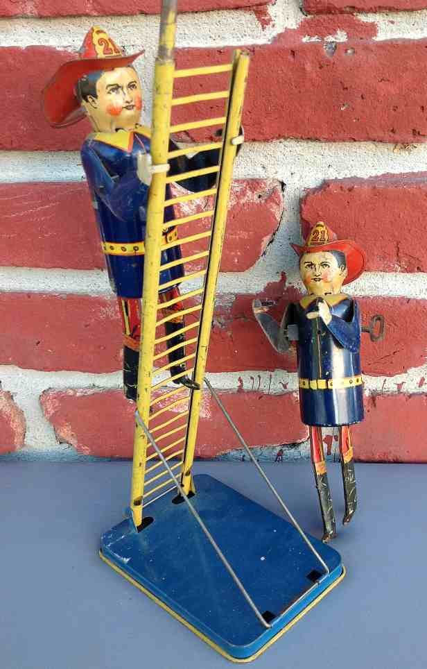 Louis Marx Tin Windup Fireman Climbing Ladder w/ Extra: Louis Marx Tin Windup Fireman Climbing Ladder w/ Extra Fireman, missing top of ladder, mechanism works, needs tweaking or cleaning....