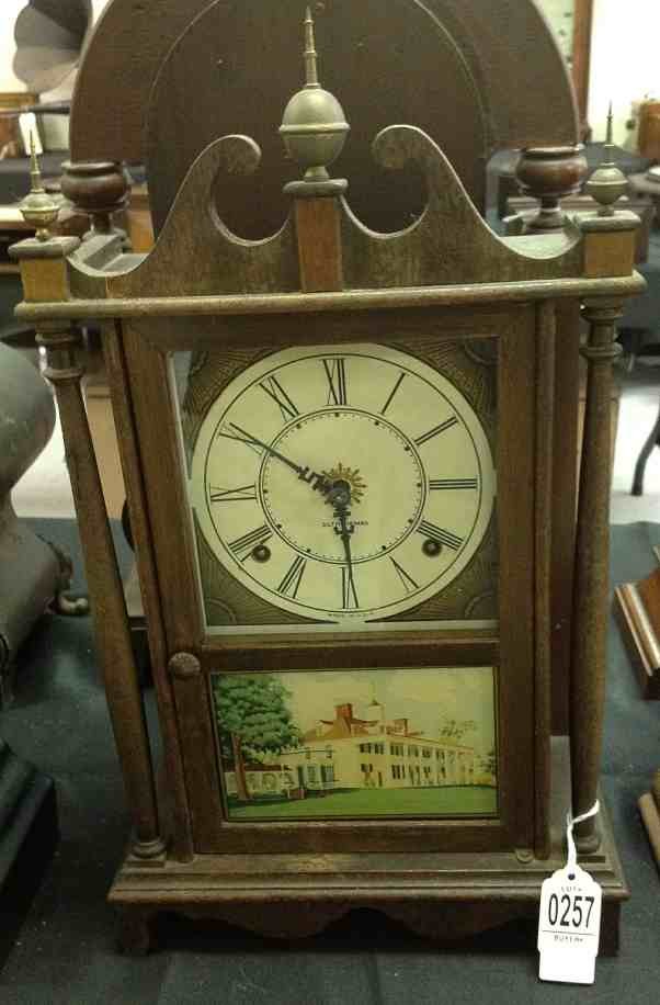 SETH THOMAS MANTLE CLOCK, WITH REVERSE PAINTED DOOR, FA: SETH THOMAS MANTLE CLOCK, WITH REVERSE PAINTED DOOR, FACE HAS BEEN REPLACED, 3 BRASS FINIALS, CASE HAS WEAR TO FINISH, MEASURES 16" HIGH