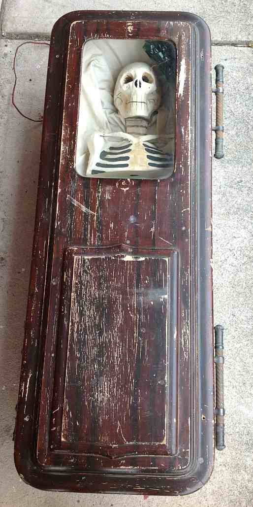 19thC ODD FELLOW Paper Mache Skeleton in Coffin: 19thC ODD FELLOW Paper Mache Skeleton in grain painted Coffin. Has original fold down handles on both sides, glass is intact over the skeleton, has a light that lights up the skeleton, and that works.