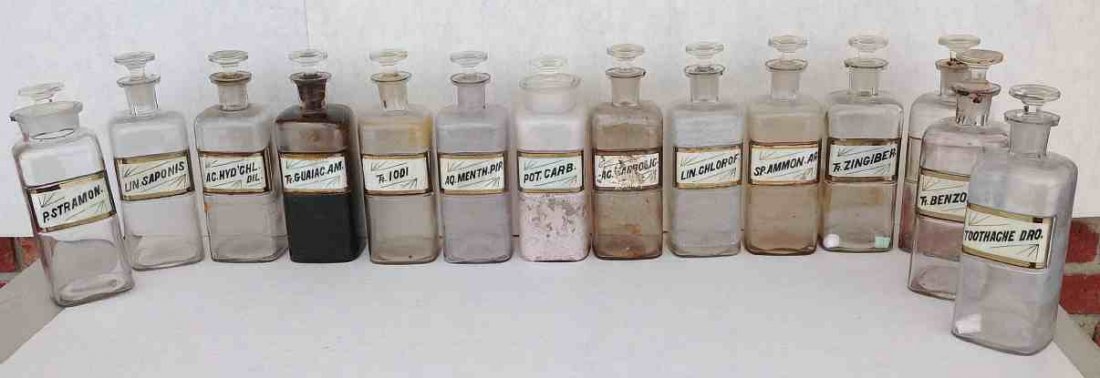 (14) 19thC Apothecary Bottles with stoppers, labels: (14) 19thC Apothecary Bottles with stoppers, labels under glass. From old Kingston, N.Y. pharmacy, some in better condition than others, some chips on rims, nice addition to a collection. Measure 10" 
