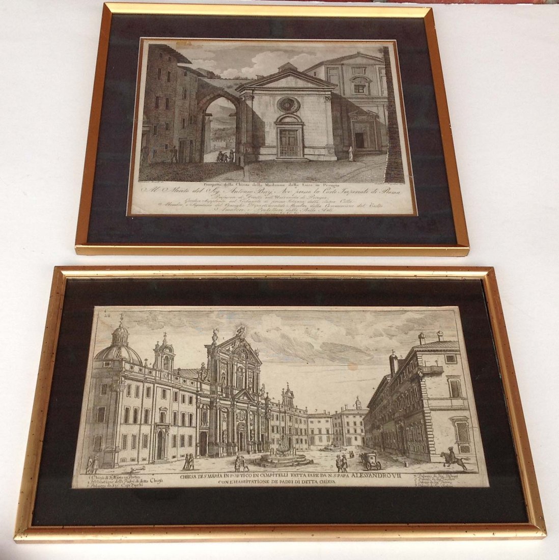 2 Early European architectural prints titled as: 2 Early European architectural prints titled as pictured in gold frames and black mats measure 10 x 12 & 8 x 14
