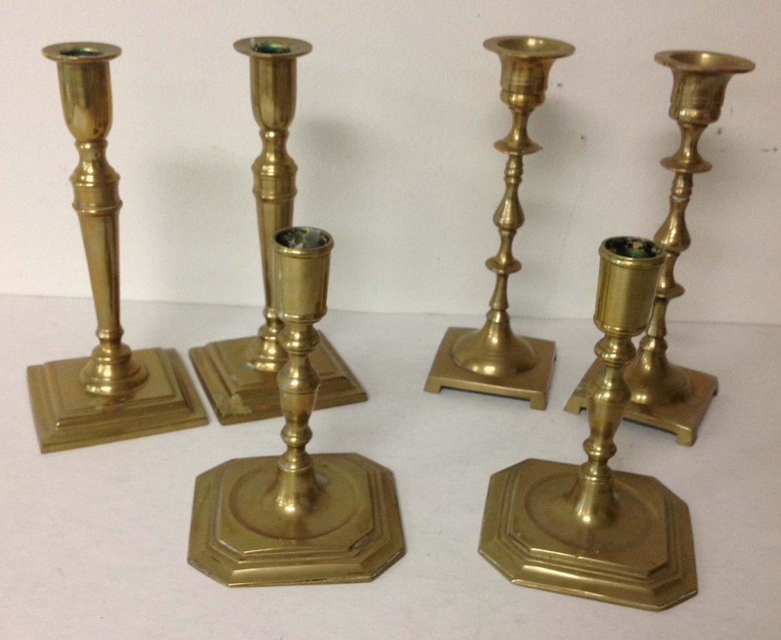 3 pair of Early Brass Candlesticks, 1 set marked Made: 3 pair of Early Brass Candlesticks, 1 set marked Made In Belgium, 1 set marked China, 1 set marked Rostand, tallest set measures 8" high, as pictured
