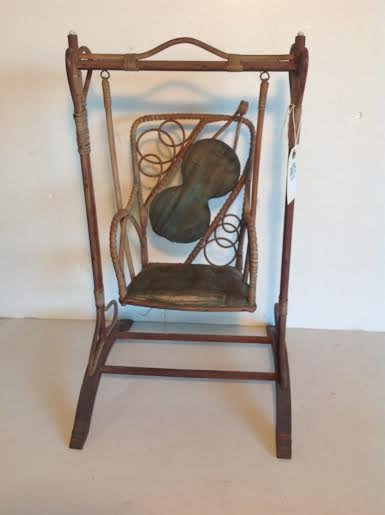 EARLY 20TH CENTURY RATTAN DOLL SWING WITH CUSHION SEAT,: EARLY 20TH CENTURY RATTAN DOLL SWING WITH CUSHION SEAT, ENAMEL ACCENT ON TOP, MEASURES 23 1/2" HIGH, 14" WIDE, WEAR ON CUSHION SEAT, AS PICTURED