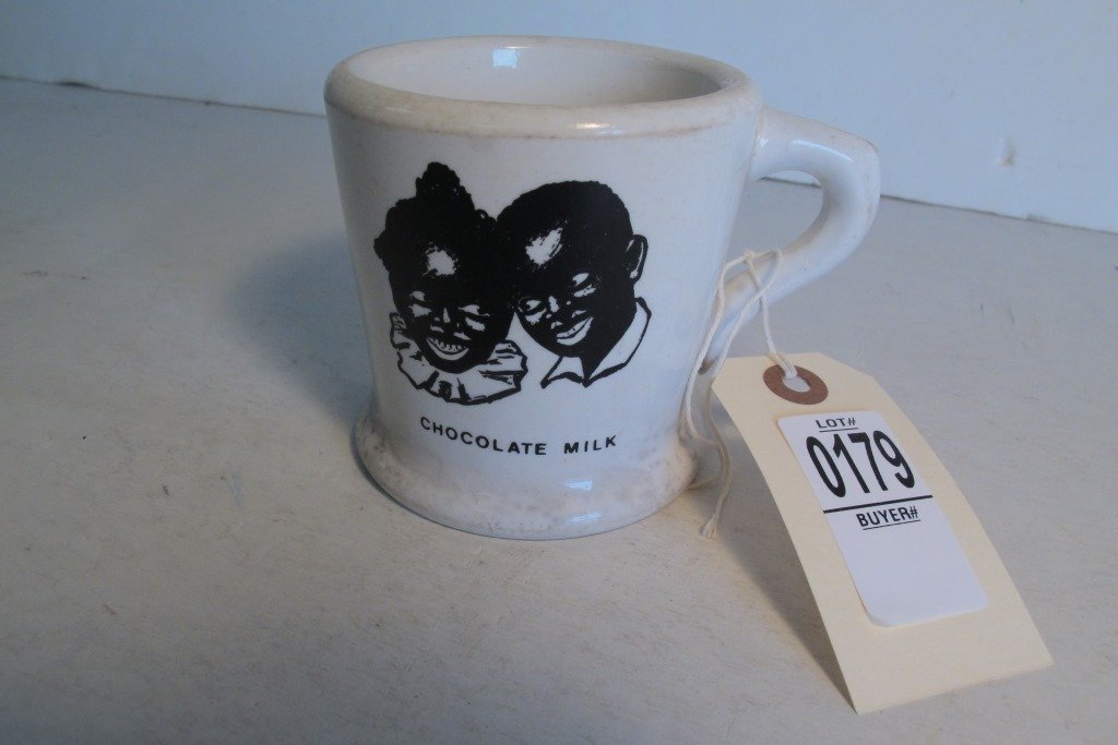 LAWRENCE DAIRIES CHOCOLATE MILK BLACK AMERICANA MUG,: LAWRENCE DAIRIES CHOCOLATE MILK BLACK AMERICANA MUG, EARLY 1900'S, SIGNED K.T.&K, CHINA, LIGHT SPOTTING, MEASURES 4" TALL, AS PICTURED