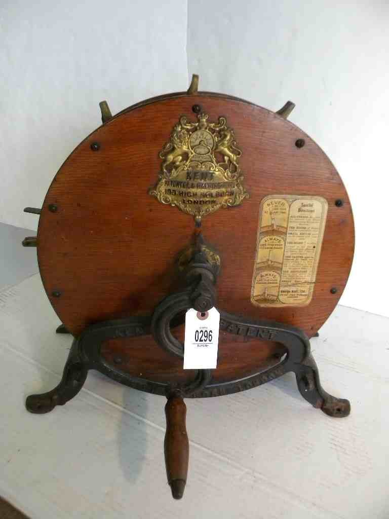 CAST IRON & WOOD KENT KNIFE SHARPENER, 19TH CENTURY,: CAST IRON & WOOD KENT KNIFE SHARPENER, 19TH CENTURY, CYLINDER SHAPE, DIRECTION LABEL ON FRONT, GEORGE KENT, LTD, LONDON, MEASURES 17 1/2"TALL, 17" WIDE, GOOD CONDITION, AS PICTURED