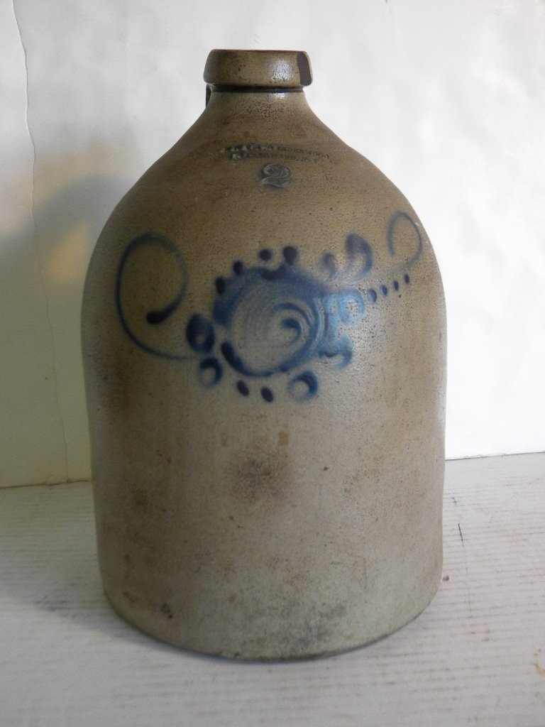 2 GALLON M. DINGER & CAIRE, PO'KEEPSIE NY STONEWARE JUG: 2 GALLON M. DINGER & CAIRE, PO'KEEPSIE NY STONEWARE JUG WITH LARGE BLUE FLOWER BURST, MEASURES 13" TALL, GOOD CONDITION, AS PICTURED