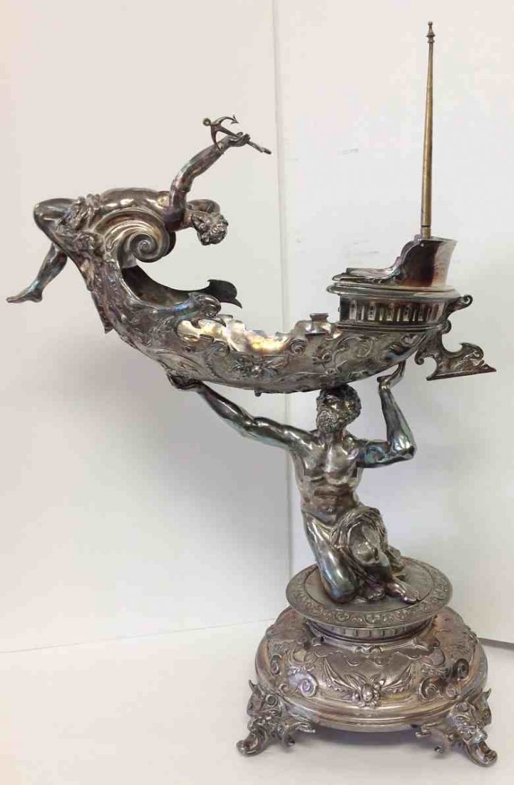 KING NEPTUNE MONUMENTAL SILVERPLATE FIGURAL COMPOTE,: KING NEPTUNE MONUMENTAL SILVERPLATE FIGURAL COMPOTE, HOLDING BOAT W/FEMALE FIGURE HOLDING AN ANCHOR, MEASURES 21" HIGH, TOP IS 17" ACROSS, HAS HEADS ON FEET, ONE FOOT HAS SEPARATION FROM BASE, MAST ON