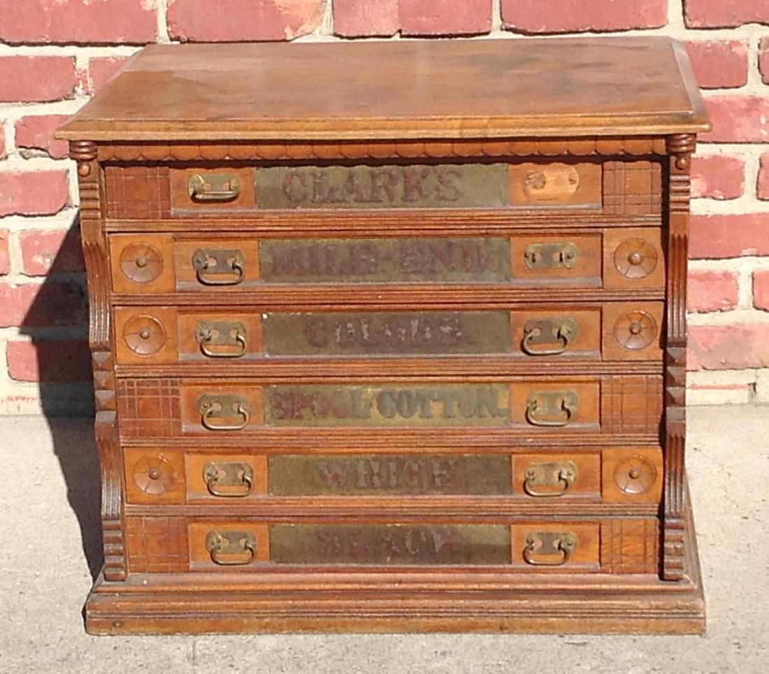 CLARKS SPOOL CABINET, 6 DRAWERS, WITH LABELS, MADE OF: CLARKS SPOOL CABINET, 6 DRAWERS, WITH LABELS, MADE OF CHESTNUT OR OAK, HAS ONE PULL OF, BUT IN DRAWER. MEASURES 22" HIGH X 25" WIDE X 18 1/2" DEEP. HAS SOME OLD STAINS ON TOP.